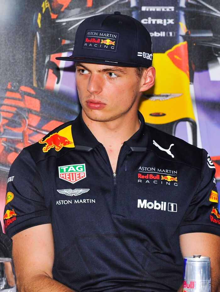 Race car driver in Red Bull Racing outfit with cap, showcasing highest paid athletes 2025 in motorsports.