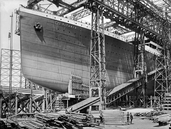 Black and white rare historical photo of the Titanic under construction, showcasing shipbuilding details and scaffolding.