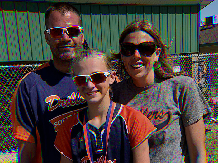 Family photo of a mom, dad, and daughter in softball uniforms relating to mom who catfished her daughter using Lo nickname.