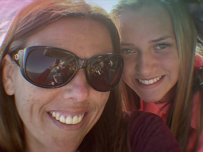 Mother and daughter smiling closely together, illustrating the context of mom who catfished her own daughter using Lo nickname.