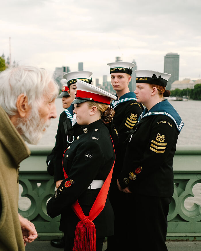 Sea Cadet Corps members in uniform stand on a London bridge, capturing the atmosphere after the Queen’s passing.