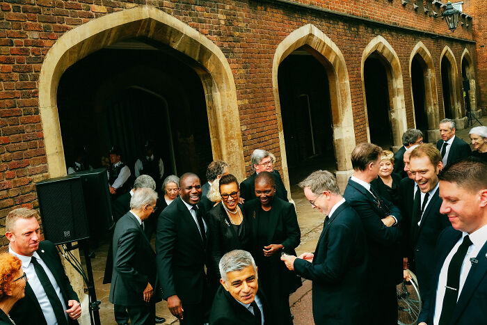 Group of people dressed formally, captured by photographer in London reflecting atmosphere after the Queen’s passing.