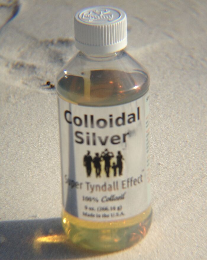 Bottle of colloidal silver solution on a surface, related to doctors encountering patients with a rare disease.