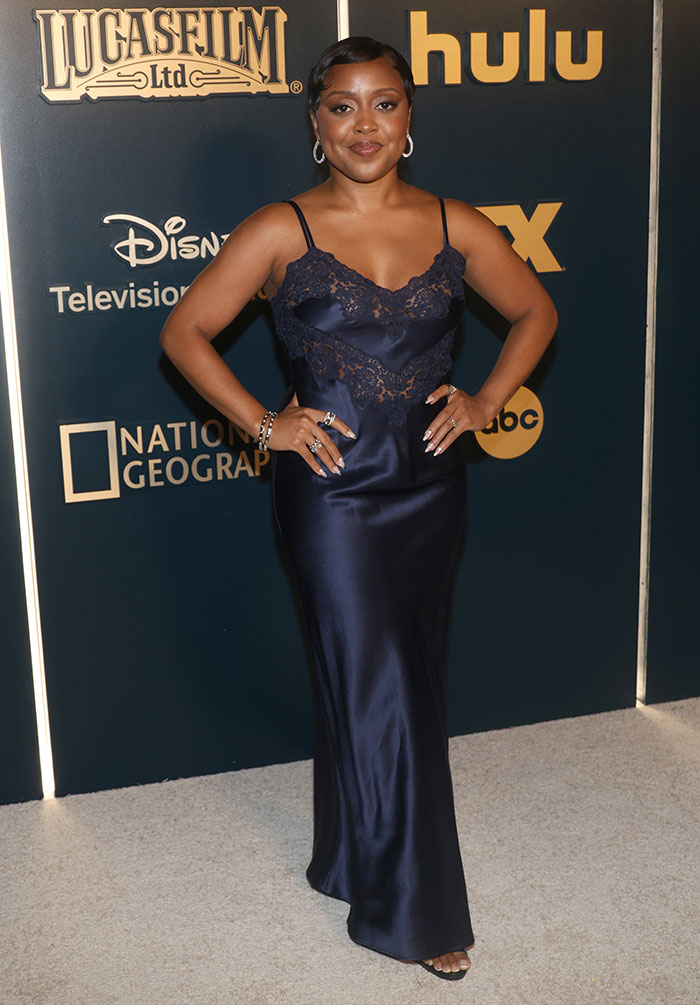 Celebrity in a navy silk gown with lace detailing at the 2025 Emmys after parties, showcasing standout outfit style.