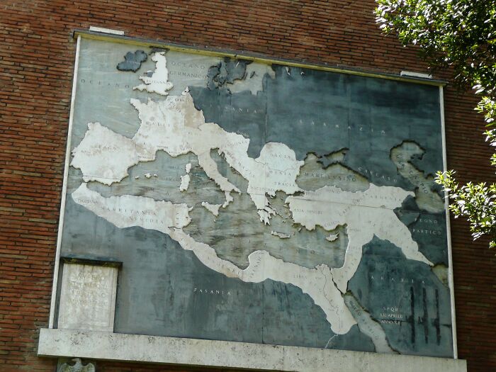 Ancient map of the Mediterranean region on a brick wall illustrating historical facts that turned out false.