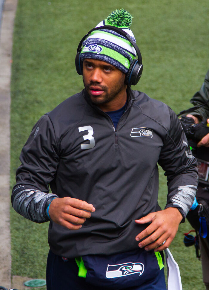 Seattle Seahawks athlete wearing headphones and team gear, representing highest paid athletes in 2025.