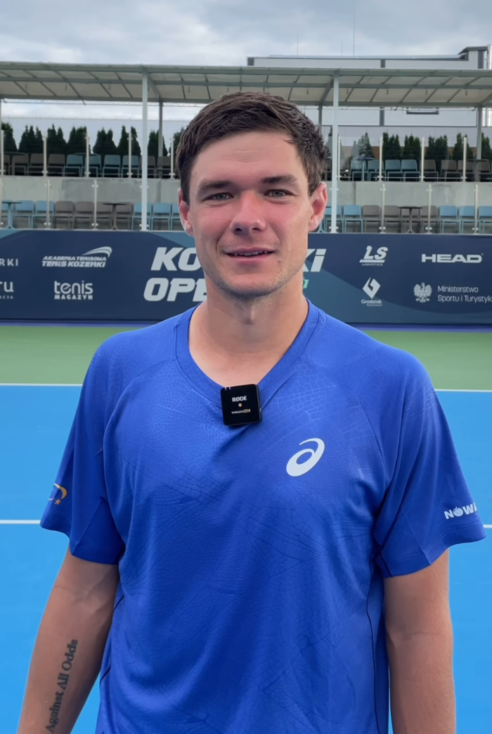 Young man in a blue shirt standing on a tennis court addressing the disgraced CEO who snatched boy's cap at US Open. Young man in a blue shirt standing on a tennis court addressing the disgraced CEO who snatched boy's cap at US Open.