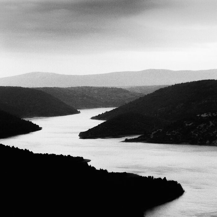 Black and white analog photo of a river winding through hills featured in the 2025 Analog Sparks Awards.