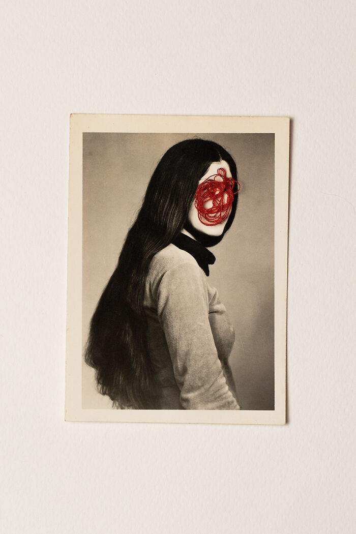 Vintage style minimalism photo of a woman with long hair and red thread scribble obscuring her face on a plain background.