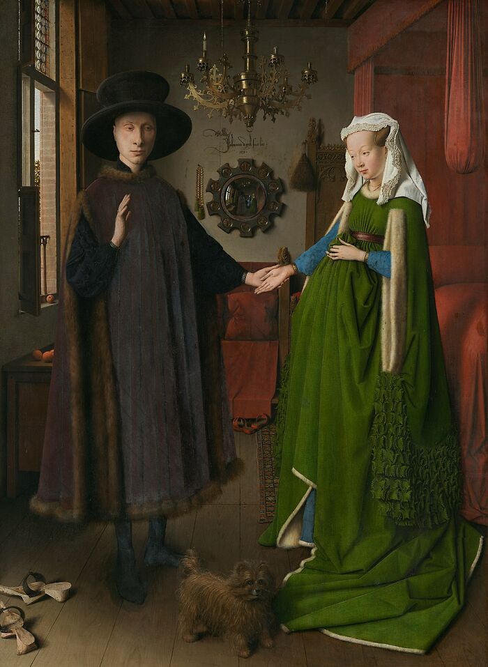 Famous timeless painting of a couple in detailed medieval attire with a small dog indoors, showcasing historic art style.