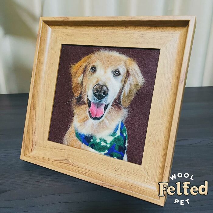 Framed wool felt pet portrait of a golden retriever wearing a green and blue bandana, showcasing realistic wool felt pets.