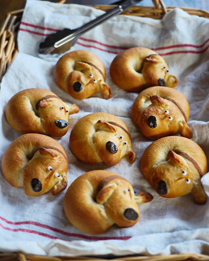 Creative meals for kids featuring dog-shaped bread rolls arranged in a basket lined with a cloth.