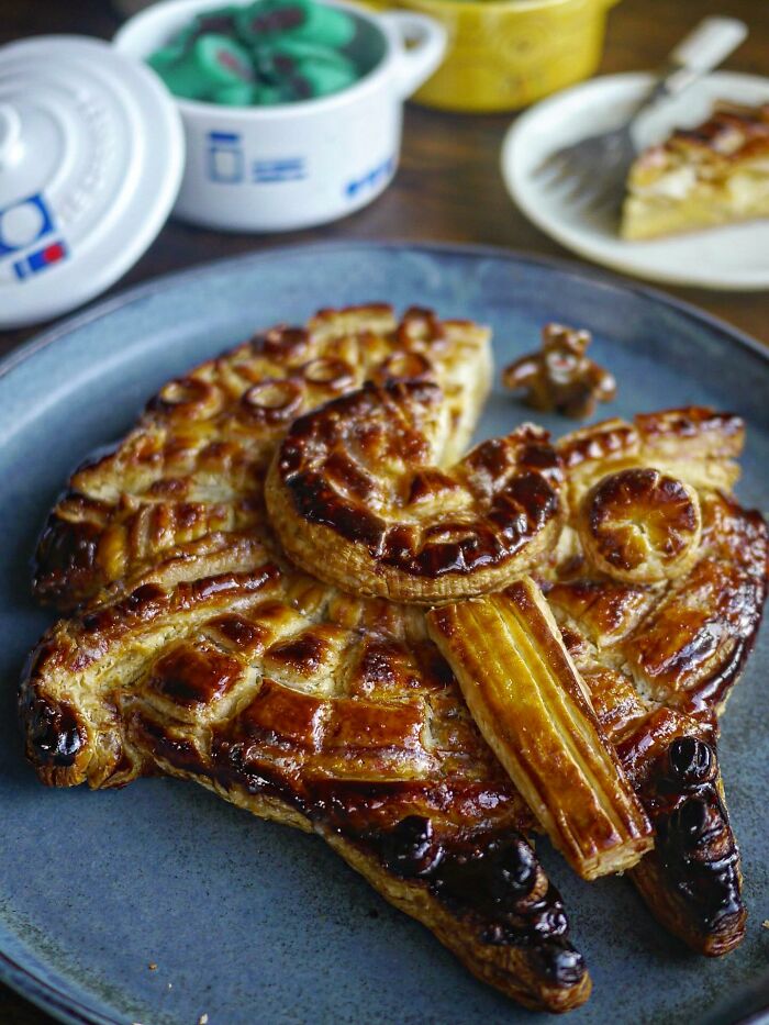 Creative meals for kids featuring a detailed baked pastry shaped like an animal on a blue plate in a home kitchen setting.