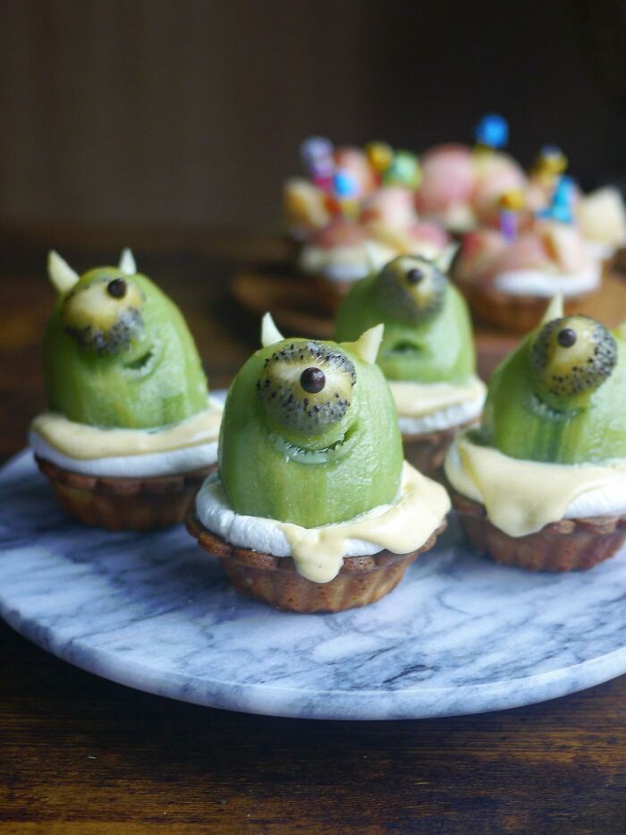 Incredibly creative meals by a Japanese mom featuring cute kiwi monster cupcakes on a marble plate for her kids.