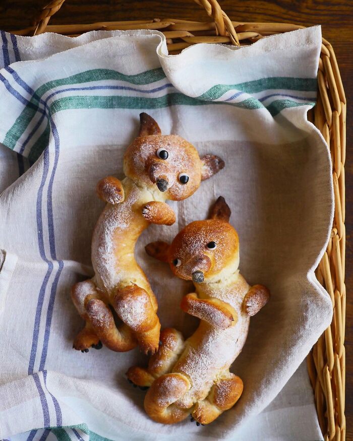 Creative meals for kids featuring adorable animal-shaped bread rolls in a basket lined with a striped cloth.