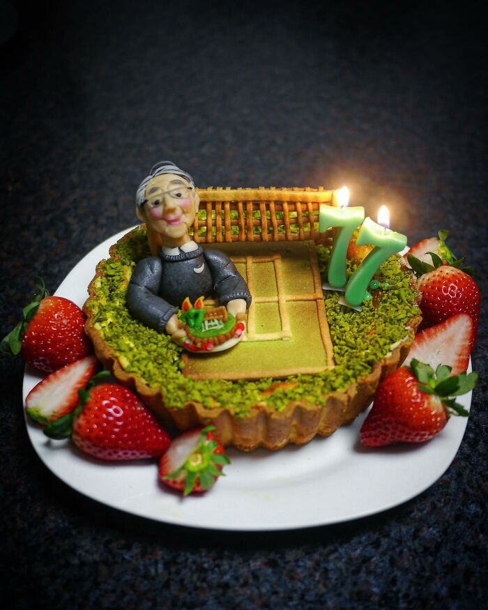 Creative meal featuring a detailed edible scene with a figure, strawberries, and candles for kids by a mom from Japan.