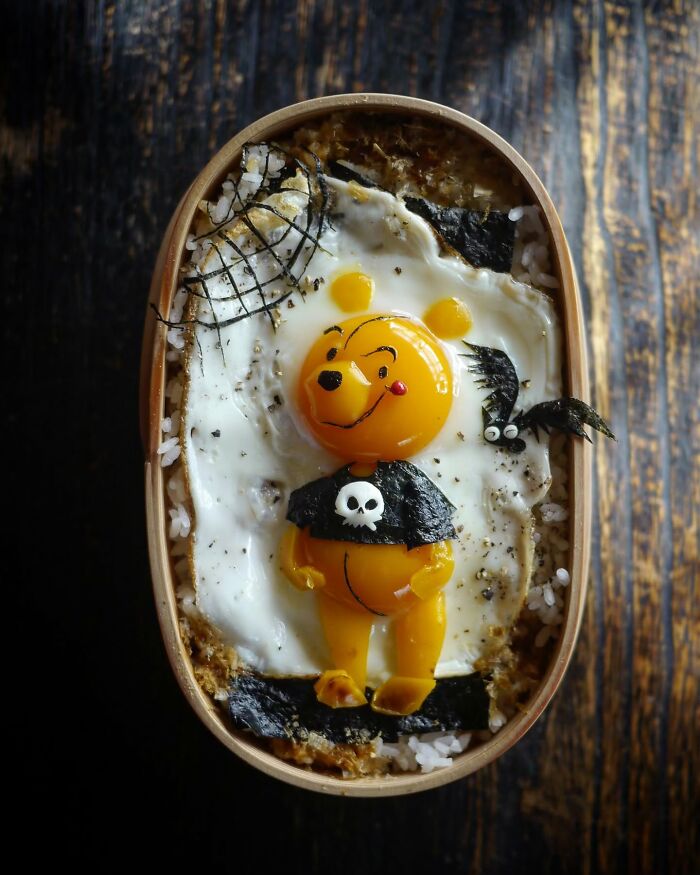 Creative meals for kids featuring a bento box with a cute bear-shaped egg and seaweed decorations on rice.