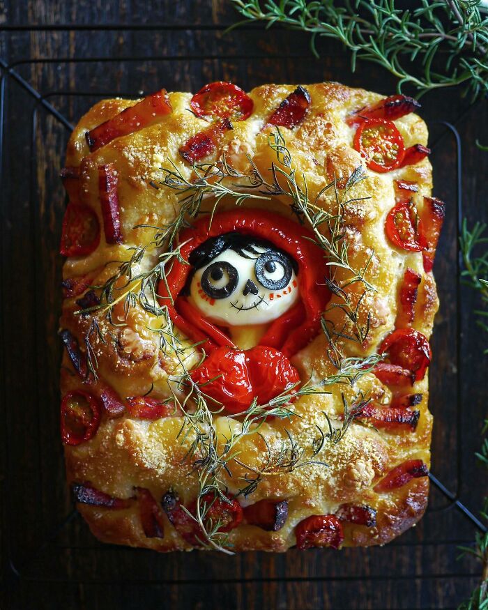 Creative meal featuring a baked dish with a character face made from boiled egg and vegetables, inspired by Japanese kids meals.