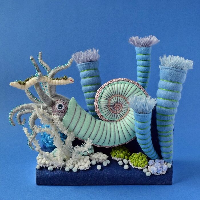 Felted artworks of a whimsical sea creature with tentacles and coral-like structures in blue and green tones.
