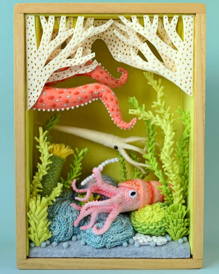 Felted artworks of sea creatures including a squid and octopus tentacles in a detailed underwater scene.