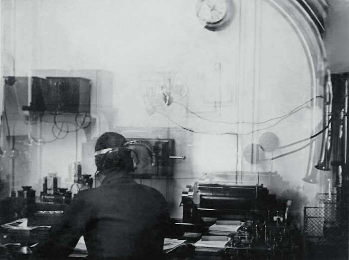 Crew member operating ship radio equipment in a rare historical photo related to the Titanic communication room.