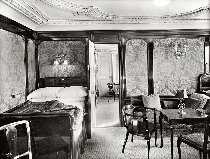 Rare historical Titanic photo showing an elegant first-class cabin with detailed woodwork and vintage furniture.