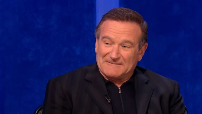 Actor sitting during an interview, reflecting on memorable experiences of meeting an idol in unexpected ways.