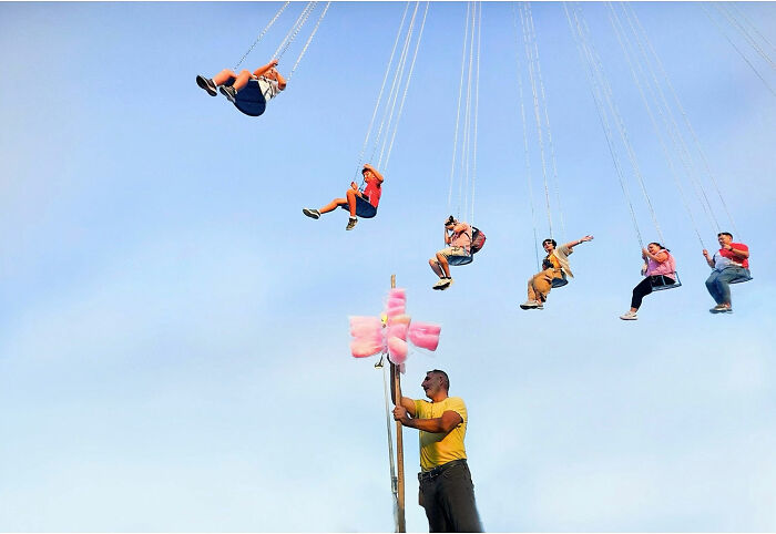 People enjoying a swing ride at an outdoor fair, capturing candid moments of everyday life in Istanbul.