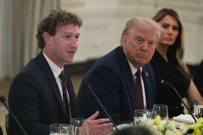 Mark Zuckerberg speaking at a formal event with Donald Trump and Melania Trump in the background.