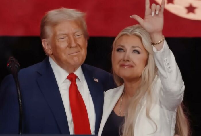 Woman making a hand gesture during funeral, sparking viral discussions and internet storm over the meaning of the gesture