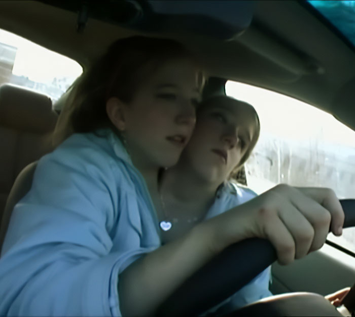 Conjoined twins Abby and Brittany sitting together in a car, expert revealing insights about who would be the mom.
