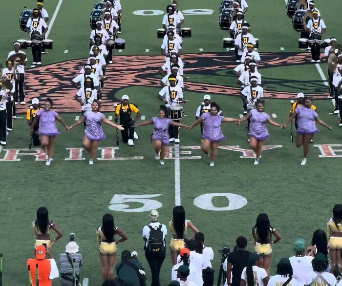 College band performers and plus-size dancers at halftime show, amid announcer bodyshaming controversy and public backlash.