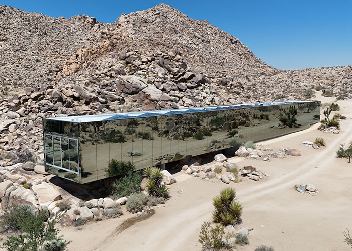 Mirrored Invisible House blending into desert landscape, an Airbnb location charging influencer $10,000 for a selfie inside.