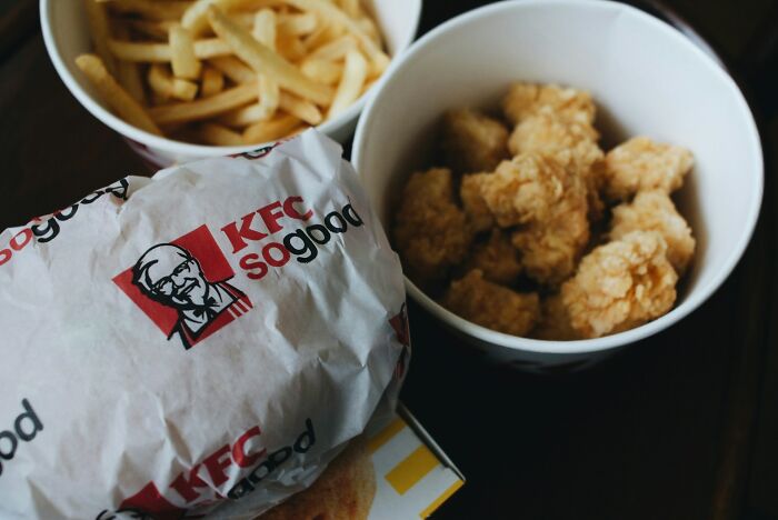 Close-up of KFC meal with fried chicken, nuggets, and fries, highlighting the brand's fast food and customer preferences.