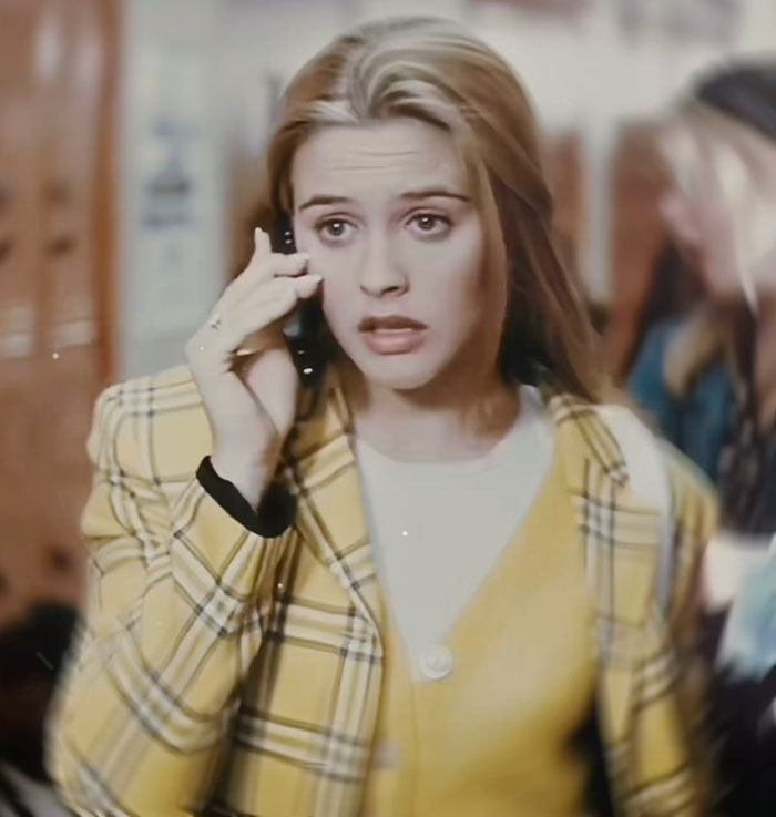 Alicia Silverstone in yellow plaid jacket speaking on phone, turning heads with youthful look in Venice setting. Alicia Silverstone in yellow plaid jacket speaking on phone, turning heads with youthful look in Venice setting.