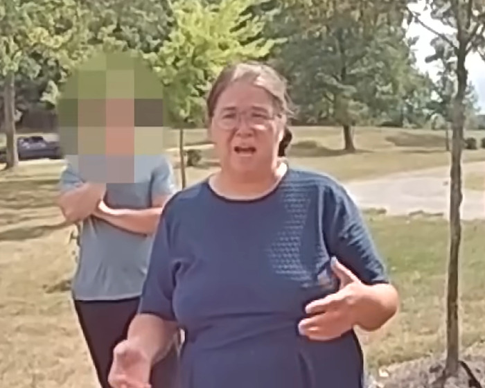 Amish mom in blue shirt making a chilling confession to officers outdoors after drowning 4-year-old son incident goes viral.