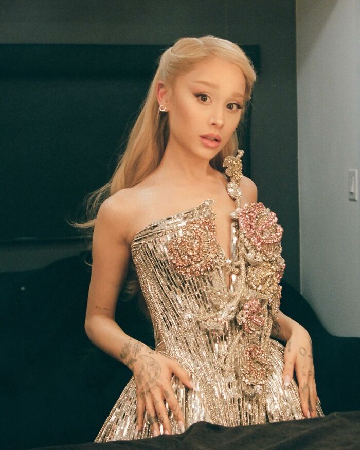 Ariana Grande posing in a sparkling floral dress with long blonde hair, amid Ethan Slater breakup rumors coverage. Ariana Grande posing in a sparkling floral dress with long blonde hair, amid Ethan Slater breakup rumors coverage.