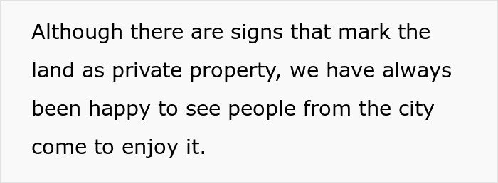 Text stating the land is marked as private property but welcomes city visitors, related to dog walking rules on private land.