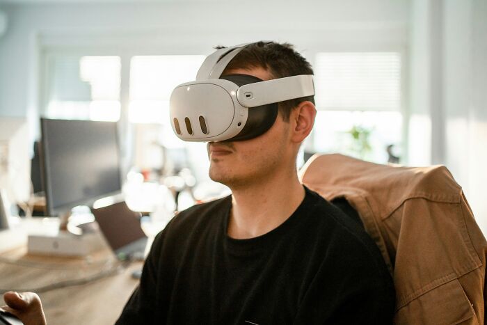 Man wearing a virtual reality headset indoors, exploring the next big thing that totally flopped in tech innovation.