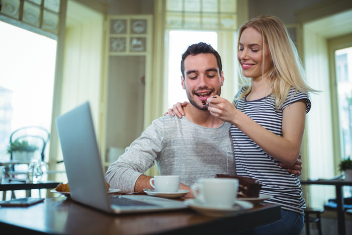 Pregnant wife feeding husband cake in cafe, unaware of affair and shock linked to dream baby name.