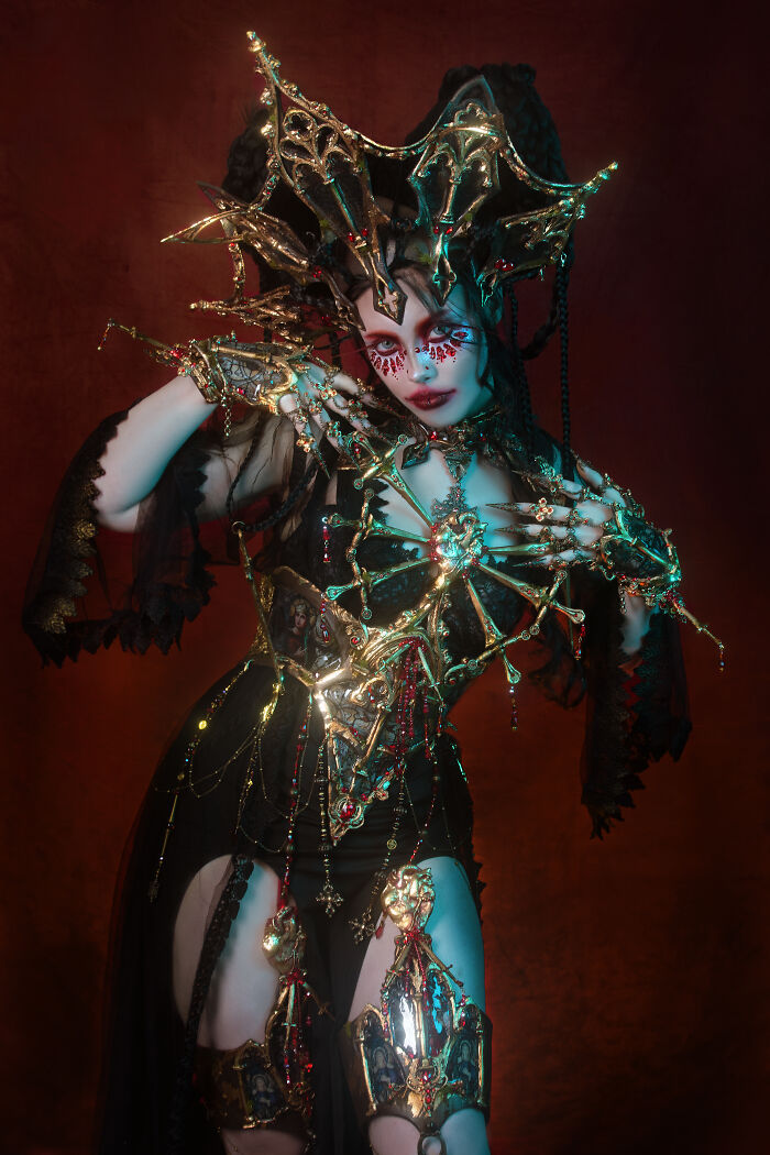 Person in intricate haunting Halloween character costume with gold and red details, transforming loved ones for yearly Halloween event.