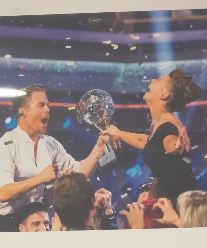 Bindi Irwin celebrating with a trophy, expressing joy and excitement as she announces moving from Australia. Bindi Irwin celebrating with a trophy, expressing joy and excitement as she announces moving from Australia.