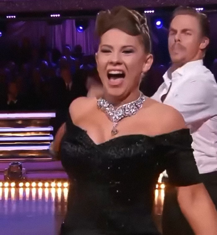 Bindi Irwin smiling and dancing in a black outfit during a lively performance, capturing her surprising decision to leave Australia. Bindi Irwin smiling and dancing in a black outfit during a lively performance, capturing her surprising decision to leave Australia.