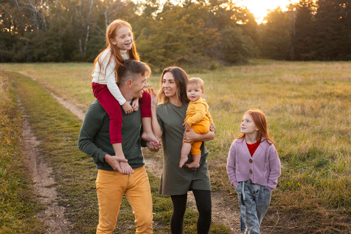 Family walking outdoors at sunset, capturing a moment of connection amid the story of man&rsquo;s birth family reunion.