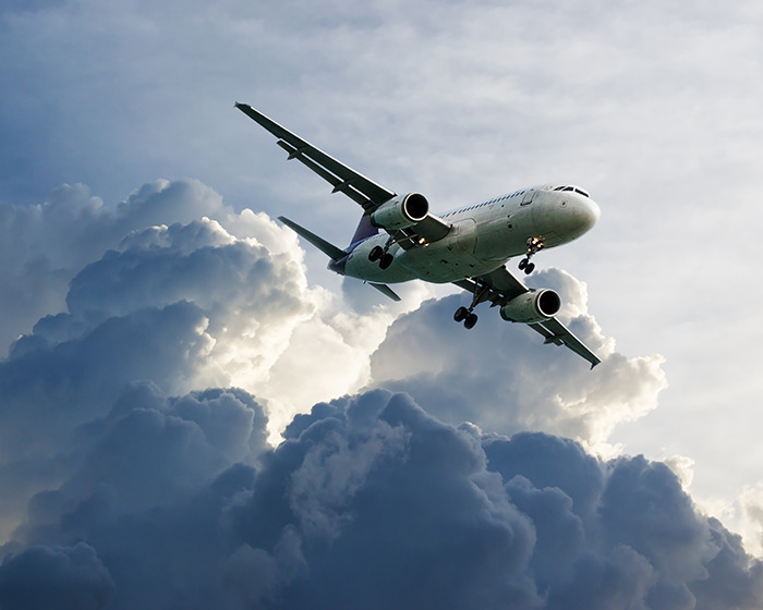 Commercial airplane flying low over dark storm clouds during a chilling plane crash simulation emergency scenario. Commercial airplane flying low over dark storm clouds during a chilling plane crash simulation emergency scenario.