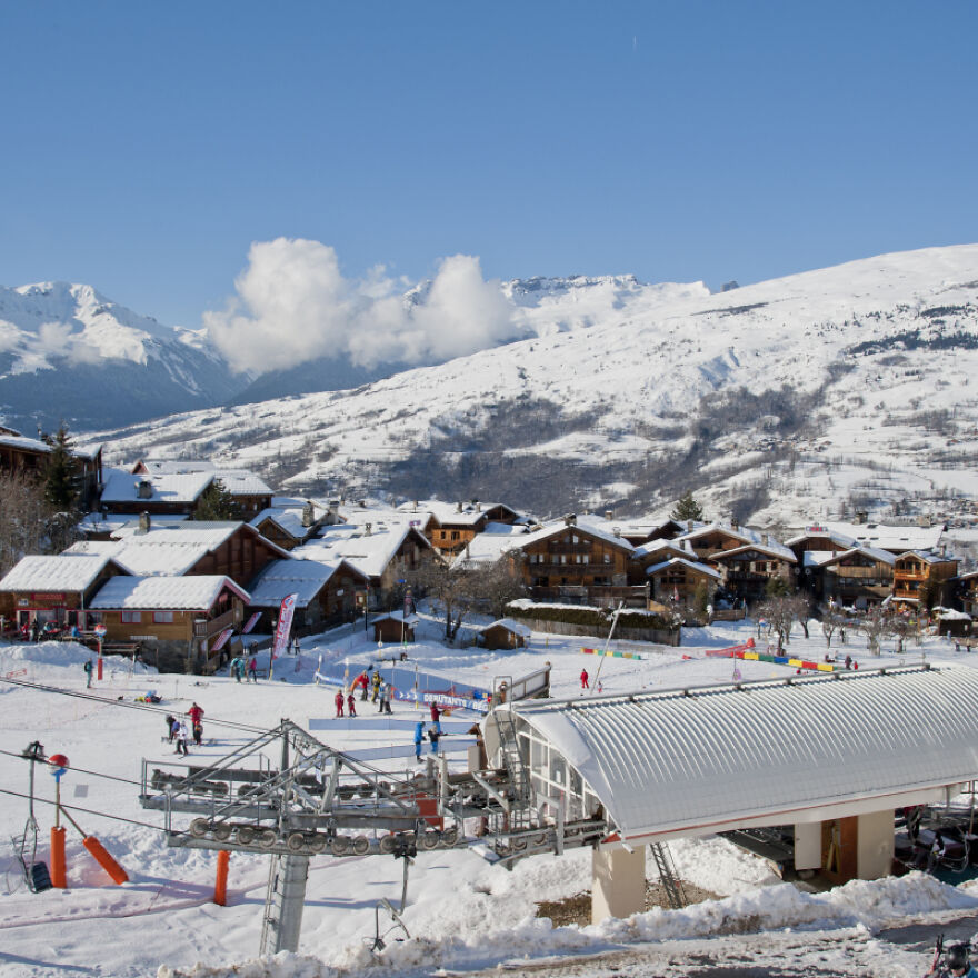 Snow-covered alpine village with ski lift and skiers, illustrating wealthy-favored superfood region linked to ALS research.