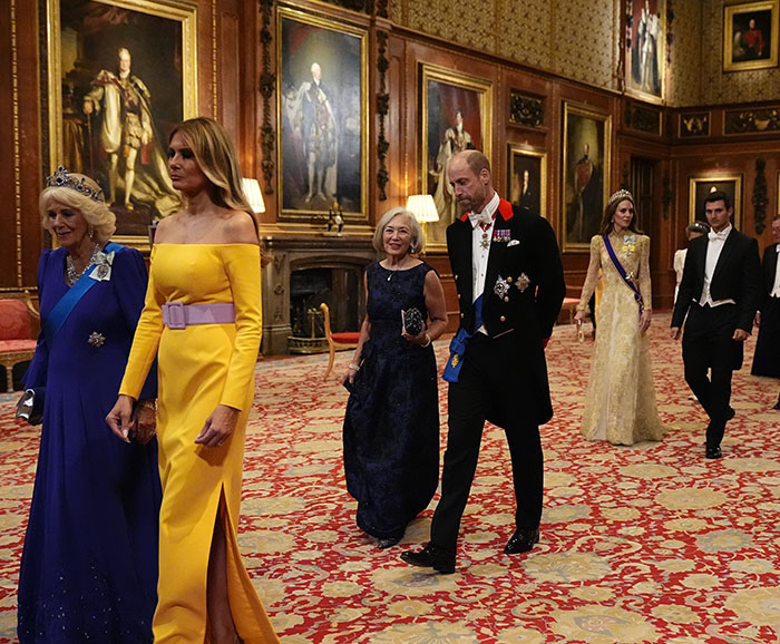 Kate Middleton walking with unexpected Trump relative at ornate state banquet in formal attire. Kate Middleton walking with unexpected Trump relative at ornate state banquet in formal attire.