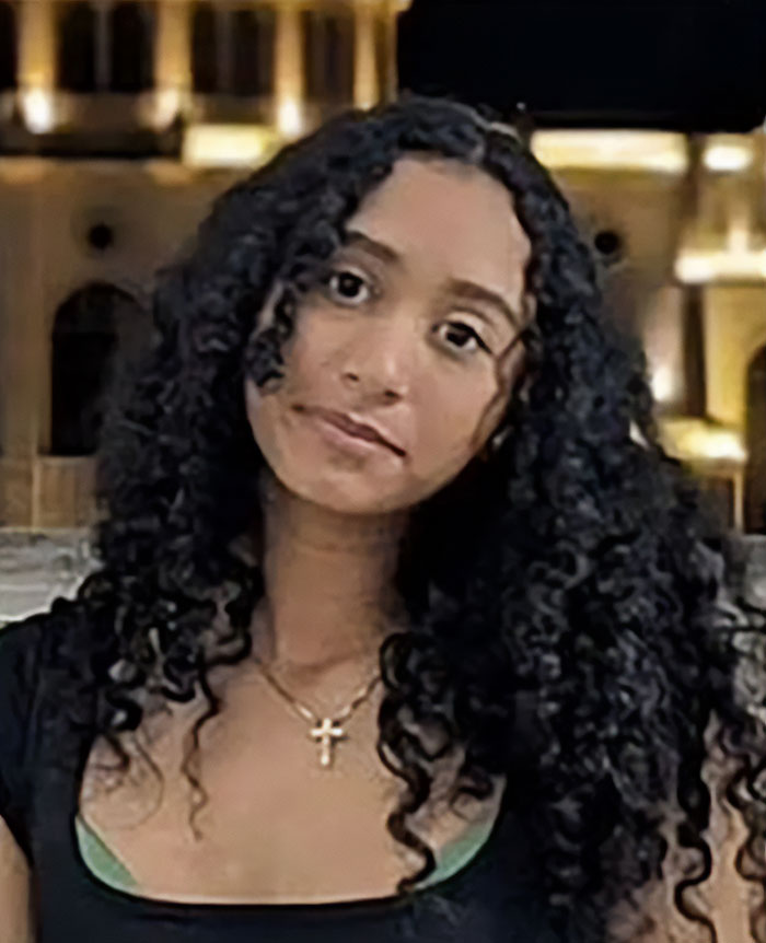 Teen girl with curly hair wearing a cross necklace, featured in news about missing girl found in singer D4vd&rsquo;s Tesla trunk.