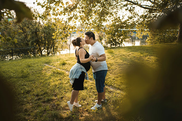 Pregnant woman and husband holding hands outdoors, highlighting risks of anaphylaxis and family conflict over peanut allergy rules. Pregnant woman and husband holding hands outdoors, highlighting risks of anaphylaxis and family conflict over peanut allergy rules.