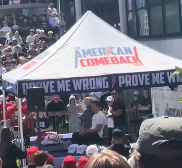 Crowd gathered around a tent with American Comeback banner during event related to Charlie Kirk eyewitness accounts. Crowd gathered around a tent with American Comeback banner during event related to Charlie Kirk eyewitness accounts.